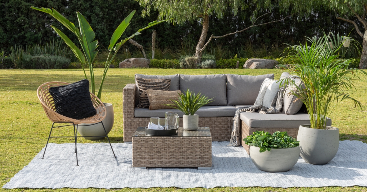 Aesthetic outdoor garden oasis with grey couch