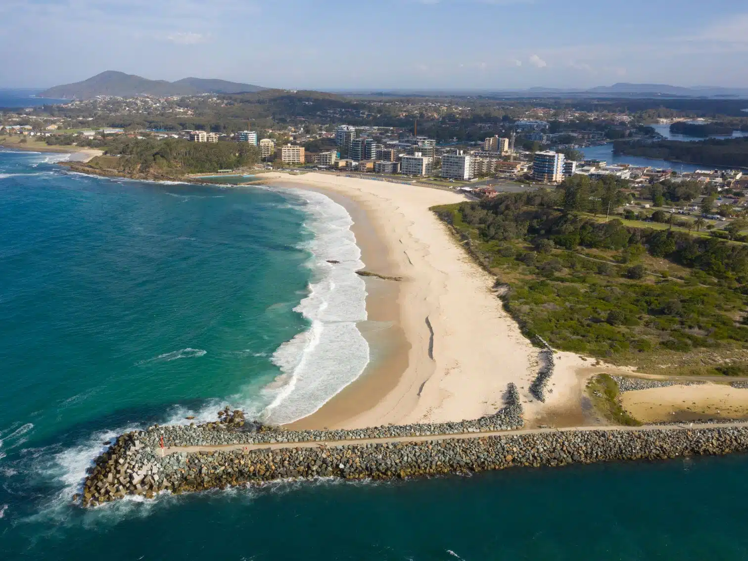 Flyover view of Forster beach and houses on the Mid Coast of NSW.