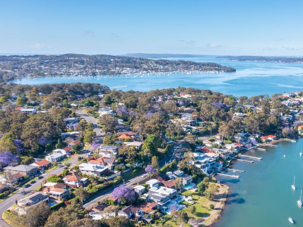 Flyover view of suburbs in the Lake Macquarie area.