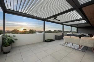Aluminium louvre roof system with outdoor ceiling fan installed on high rise balcony in Newcastle area of NSW.