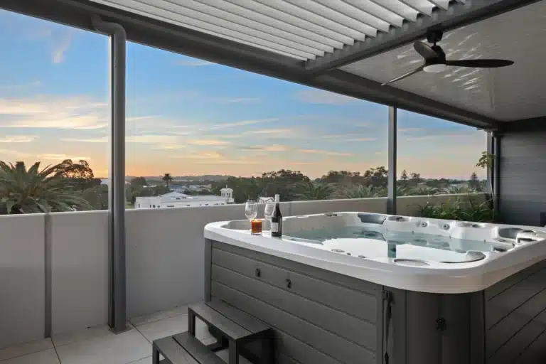 View of the sunset from the spa underneath the louvred roof.